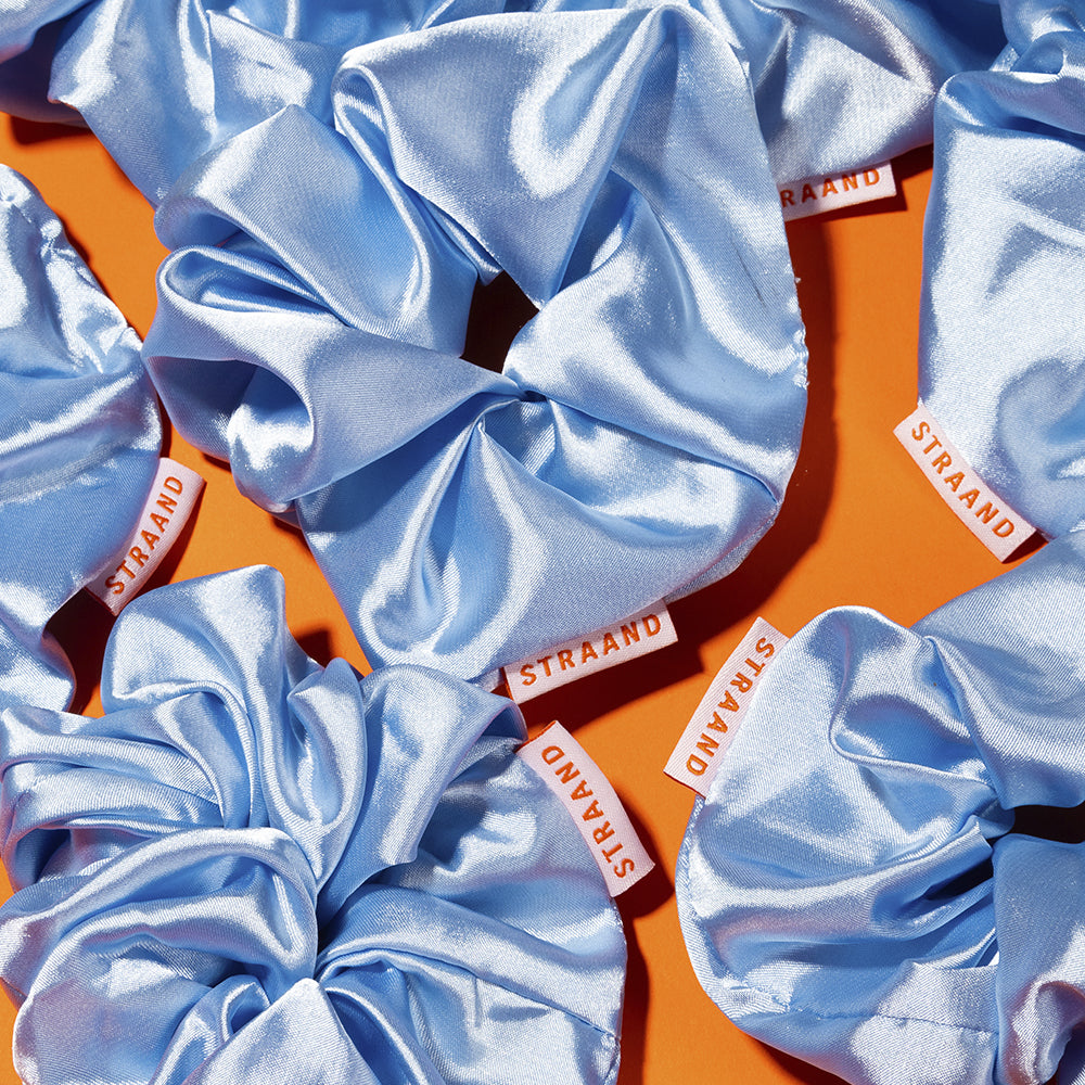 The multi-purpose scrunchie that serves - pile of blue satin STRAAND scrunchies