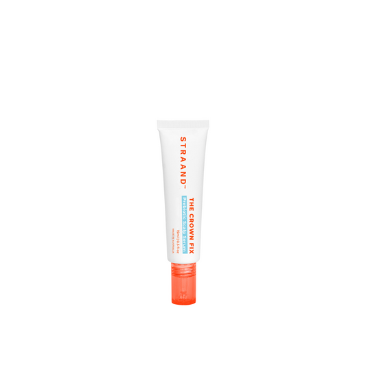 A mini-sized tube of Crown Fix Scalp Serum with a white body and orange cap, labeled with the product name and branding.
