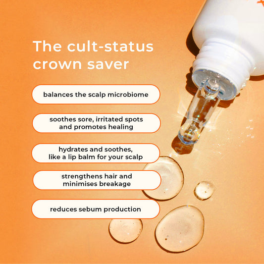 A mini-sized tube of Crown Fix Scalp Serum with a white body and orange cap, labeled with the product name and branding.